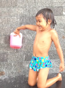 This little girl was taking her bath, mid-morning, in the middle of Bangkok